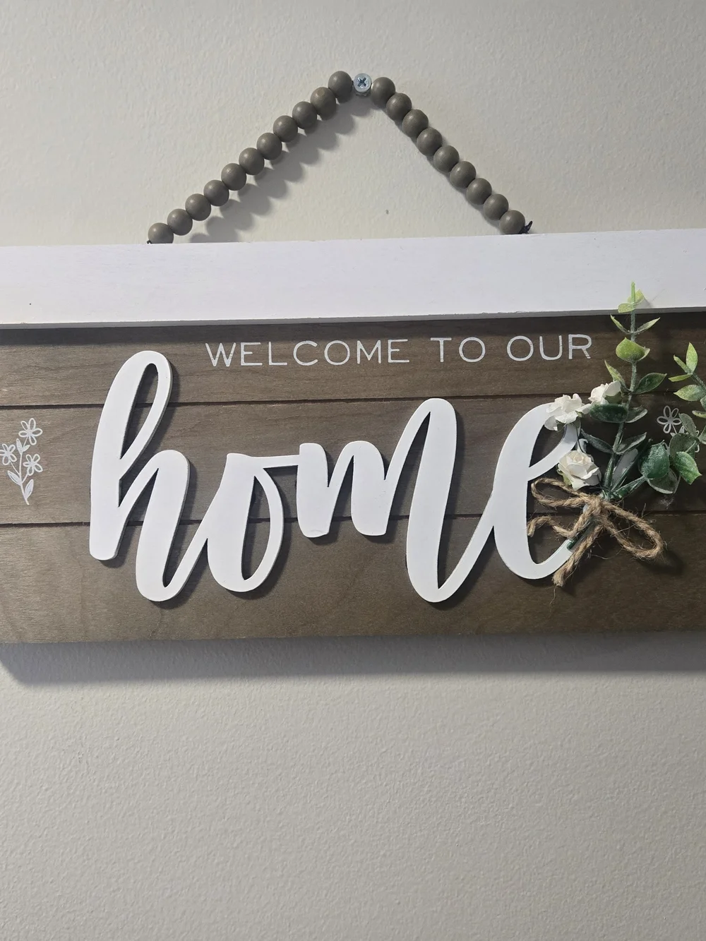 Welcome to Our Home Wooden Wall Sign - White Script on Brown
